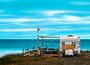 white and brown campervan on beach shore